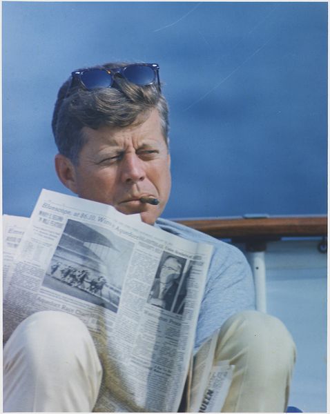 Soubor:Hyannisport Weekend. President Kennedy with cigar and New York Times. Hyannisport, MA, aboard the Honey Fitz-NARA-194268.jpg
