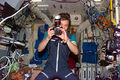 S84E5122-STS-084-Lazutkin is photographed holding a 35mm camera in the Mir space station-DPLA.jpg