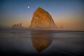 Light from the sunrise hits Haystack Rock as the moon sets above on Cannon Beach, Oregon Coast-Flickr.jpg