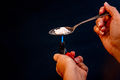 Addiction and drugs. Preparing drugs with a spoon and lighter-Flickr.jpg