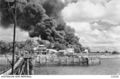 Oil tanks on Stokes Hill burning during the first Japanese air raid, Feb 1942.JPG